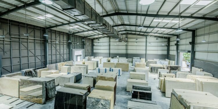 Expansive warehouse filled with large stone slabs for industrial use. Understanding Resource Management for a Better Planet