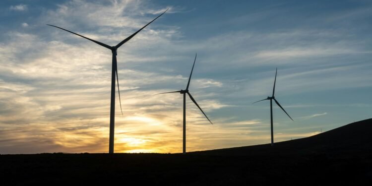 A scenic view of wind turbines against a sunset sky, symbolizing renewable energy. Green Technology: Innovations for a Better Planet