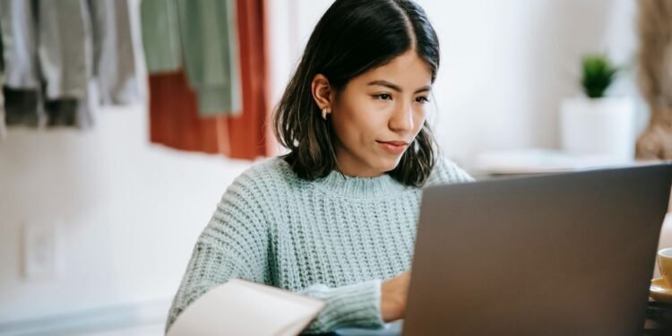 A young woman in a cozy room working on a laptop, showing concentration and dedication. 7 Best online learning platforms in 2025